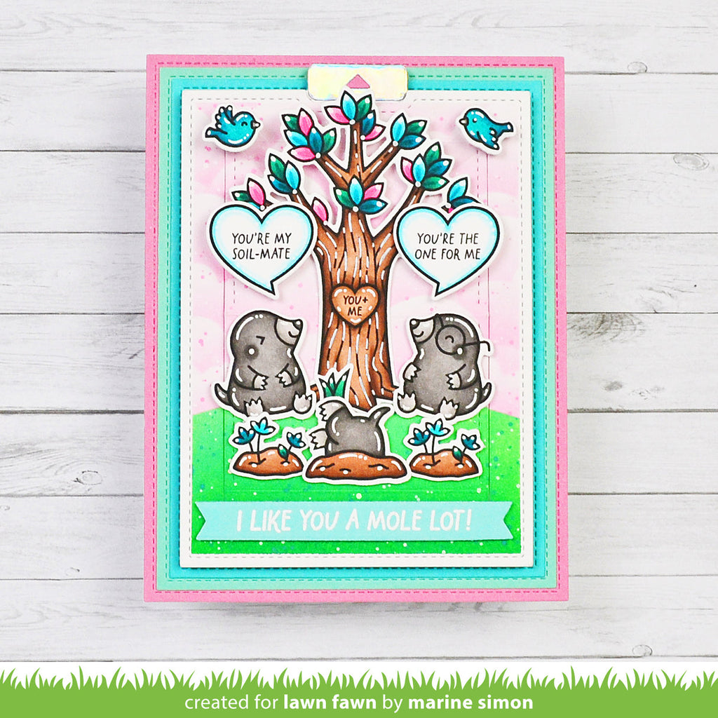 Card with cartoon moles and tree, featuring text 'You're my soul mate' and 'I like you a mole lot!' on a wooden background.