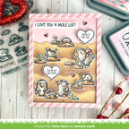 Valentine's Day card with mole design and text, surrounded by stamping tools on a wooden surface.