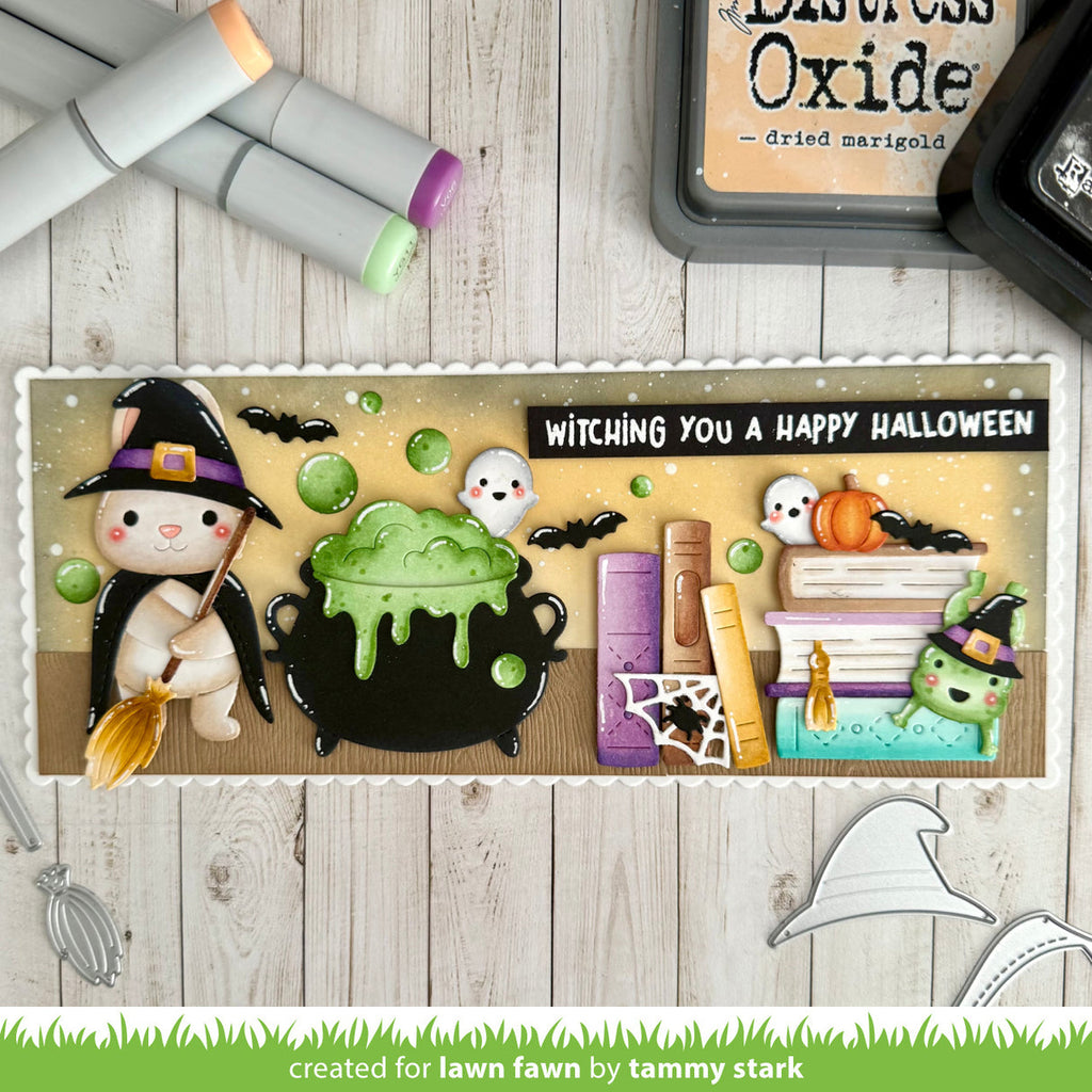 Halloween-themed card with cartoon characters and text on a wooden surface.
