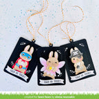 Three Halloween-themed rabbit figurines on black cards with decorative strings against a light blue background.