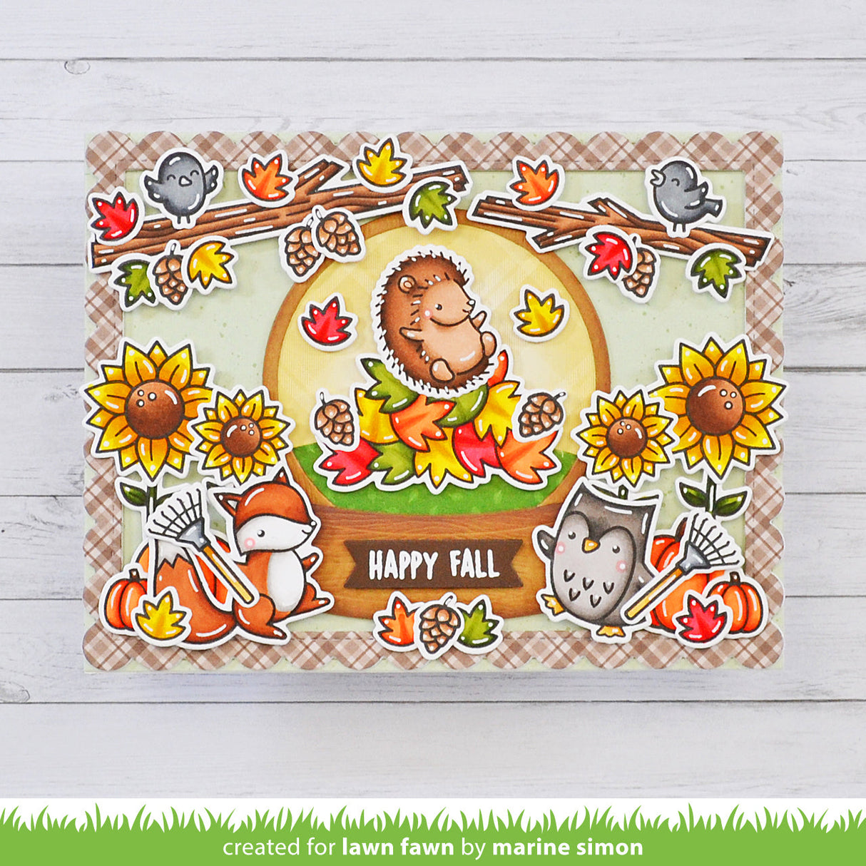 Autumn-themed card with hedgehog, fox, owl, and fall elements on a plaid background.