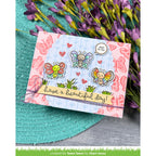 Card with butterfly designs and text 'have a beautiful day!' on a floral background