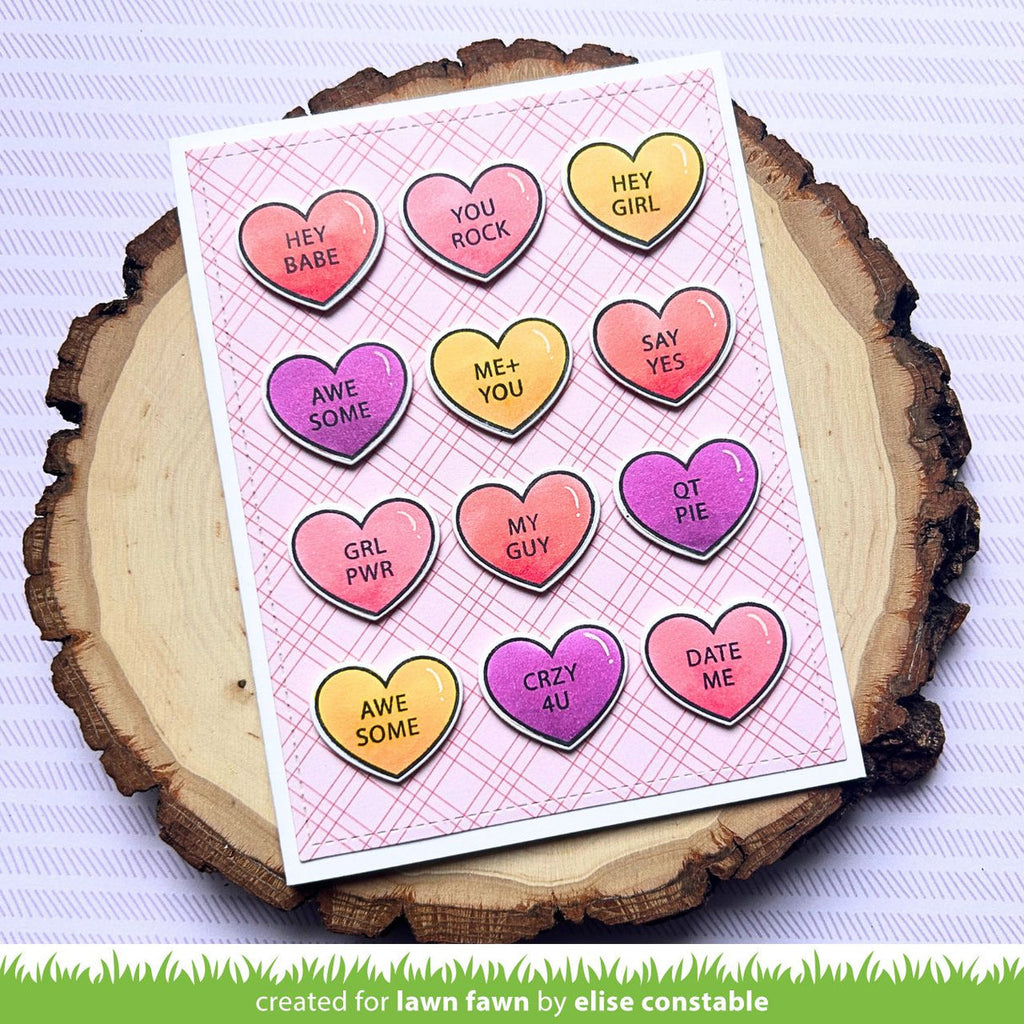 Card with heart-shaped die pattern on a wooden surface