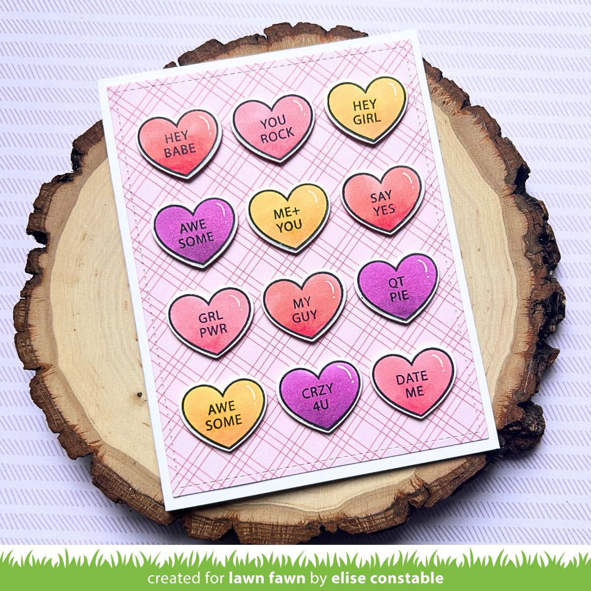 Card with heart-shaped die pattern on a wooden surface