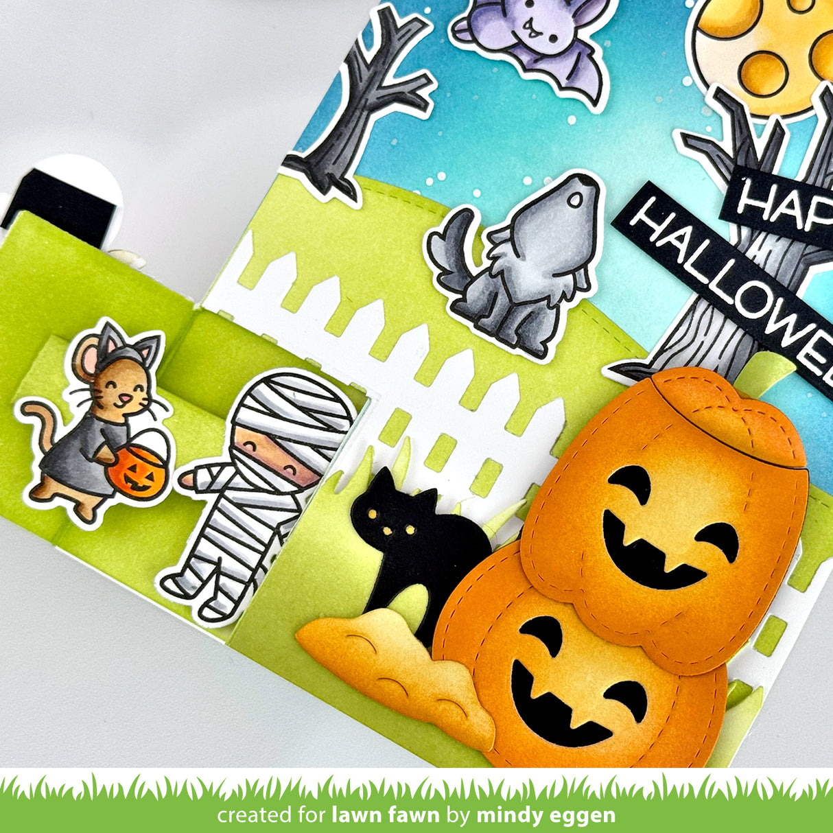 Halloween-themed card with pumpkins, cat, and mummy stickers on a white background. | color-code:alt1