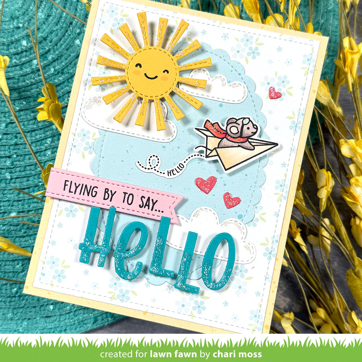 Handmade card with a sun, bird, and 'hello' text on a textured background
