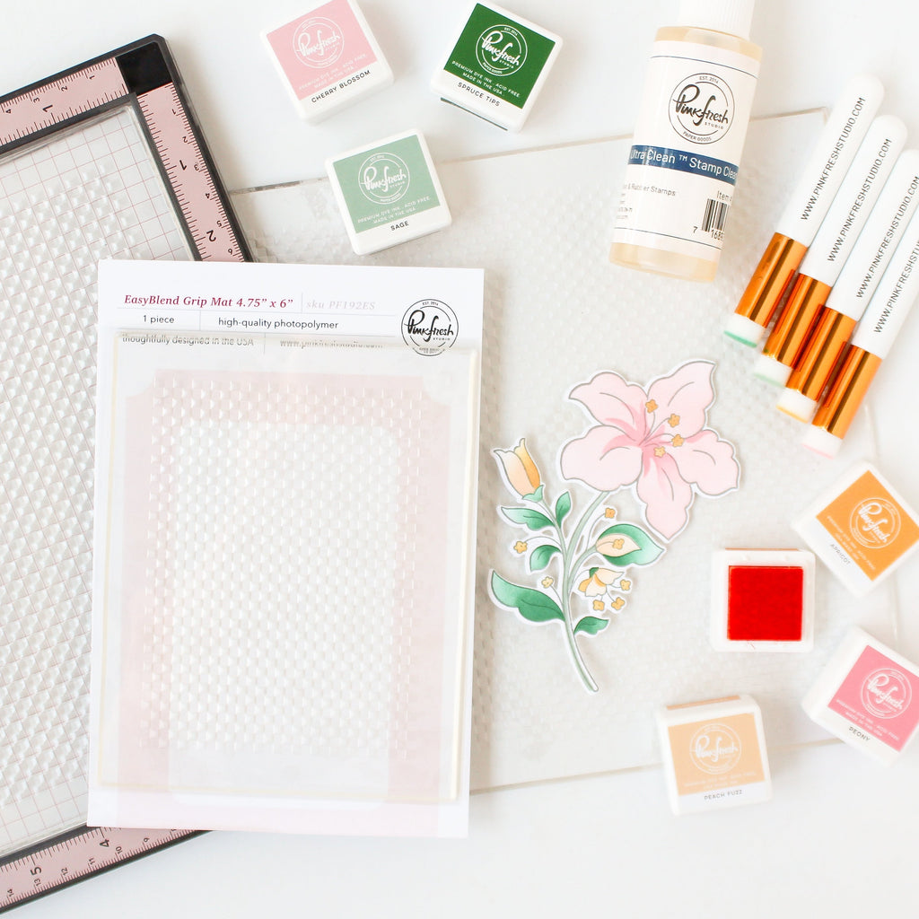 Pinkfresh Studio 8.5 x 11 EasyBlend Grip Mat pf191es on Desk glamour shot with inks and tools