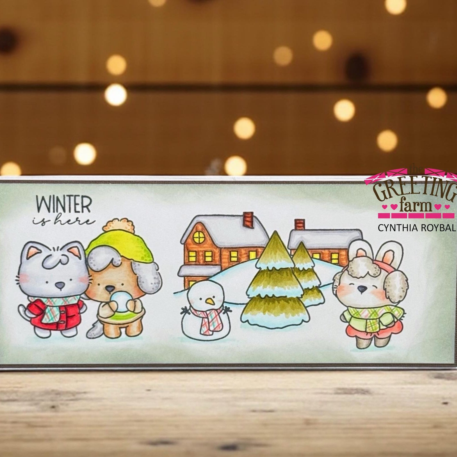 Card with winter-themed illustration of animals and a house, featuring 'The Greeting Farm' branding. | color-code:ALT02