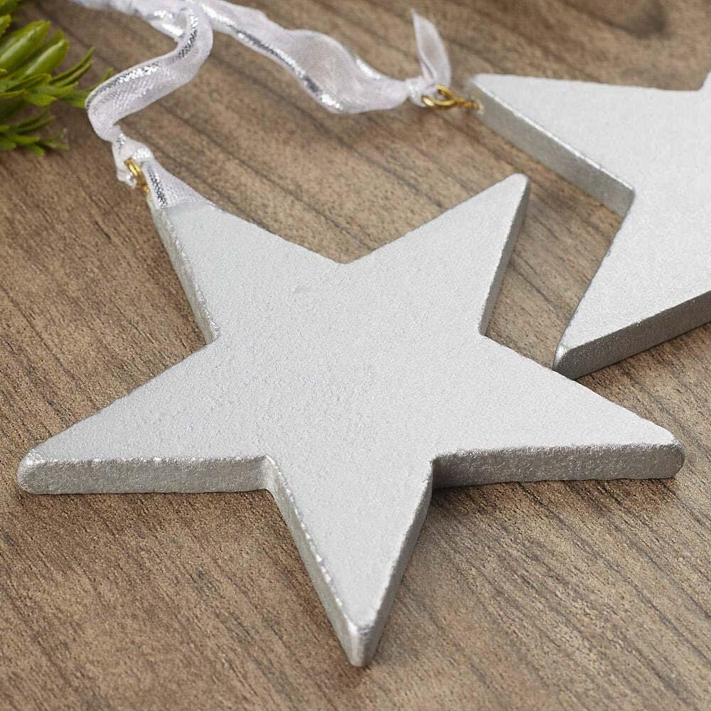 Silver star-shaped ornament on a wooden surface